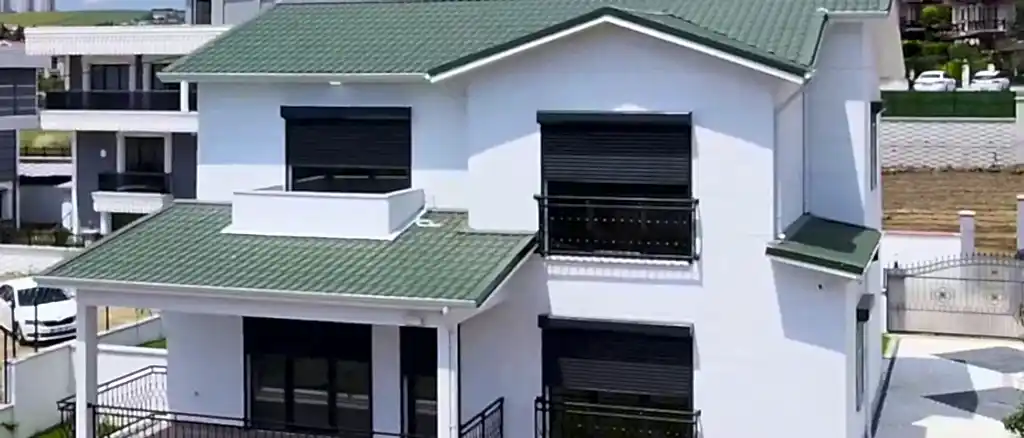 Şehir içinde balkonlu, yeşil çatılı modern çelik ev